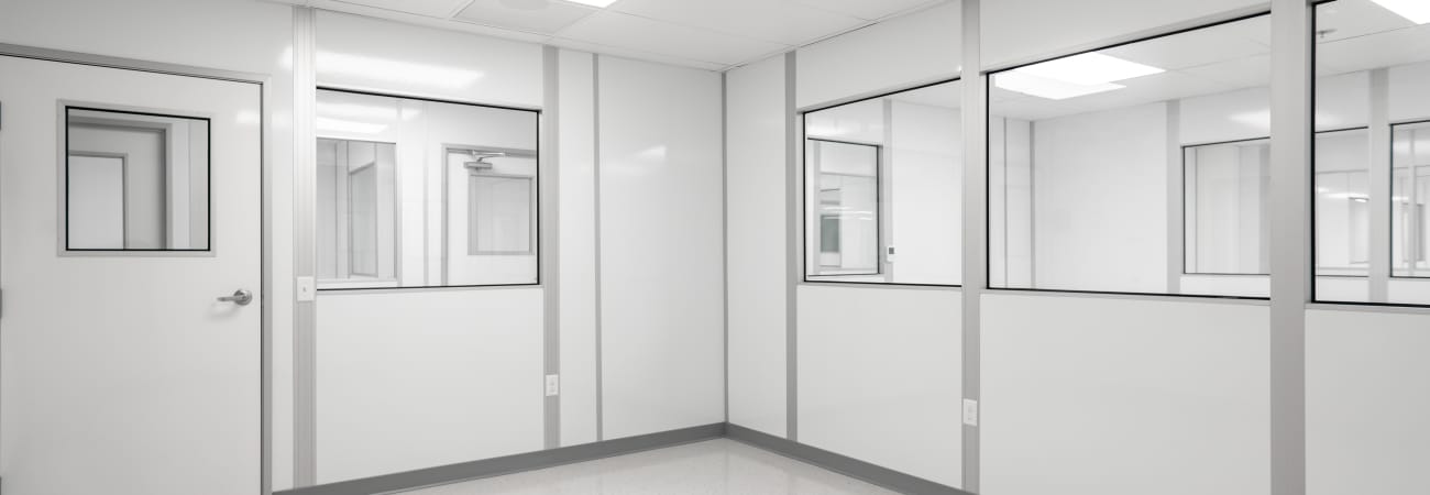 Allied Cleanroom's controlled environment with modular wall finishes, featuring smooth, easy-to-clean surfaces and integrated windows.
