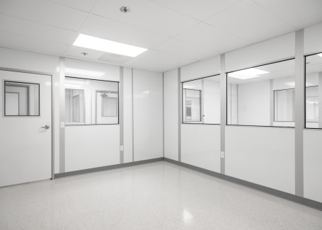 Allied Cleanroom's controlled environment with modular wall finishes, featuring smooth, easy-to-clean surfaces and integrated windows.