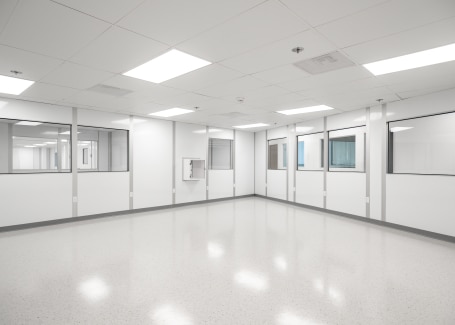 Modular white room with bright LED lighting, clean panel walls, and integrated viewing windows, built by Allied Cleanrooms.