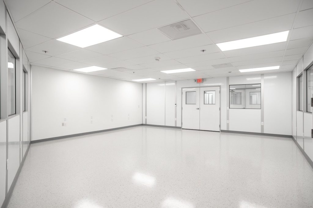 Interior view of a modular nanotechnology cleanroom by Allied Cleanrooms, featuring seamless flooring and clean white wall panels.