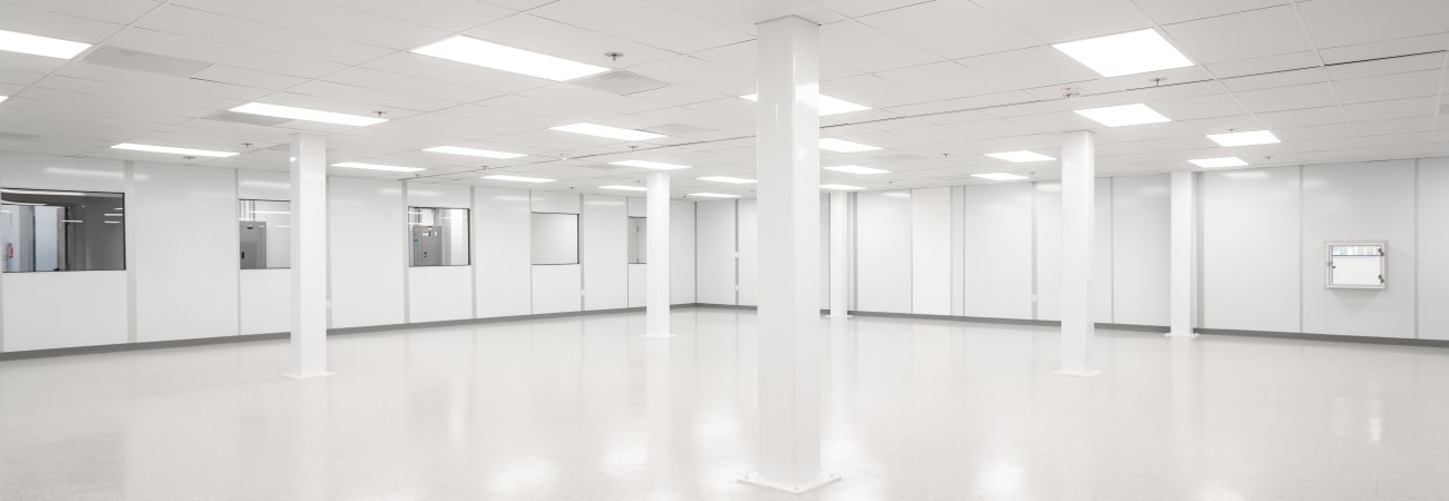Spacious modular cleanroom with white walls, bright lighting, and a controlled environment.