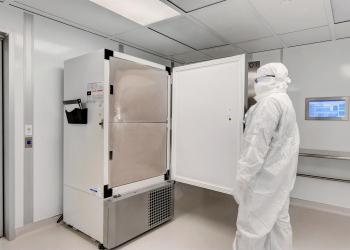Aseptic cleanroom built by Allied Cleanrooms with gowned technician