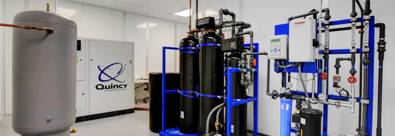Water treatment and air compressor equipment installed inside a modular cleanroom by Allied Cleanrooms.