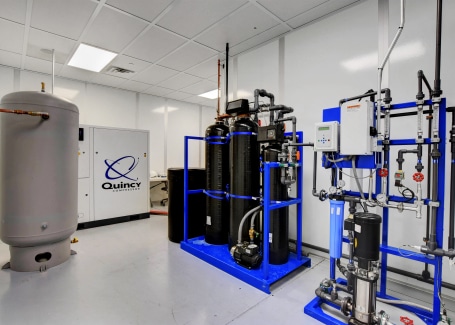 Water treatment and air compressor equipment installed inside a modular cleanroom by Allied Cleanrooms.