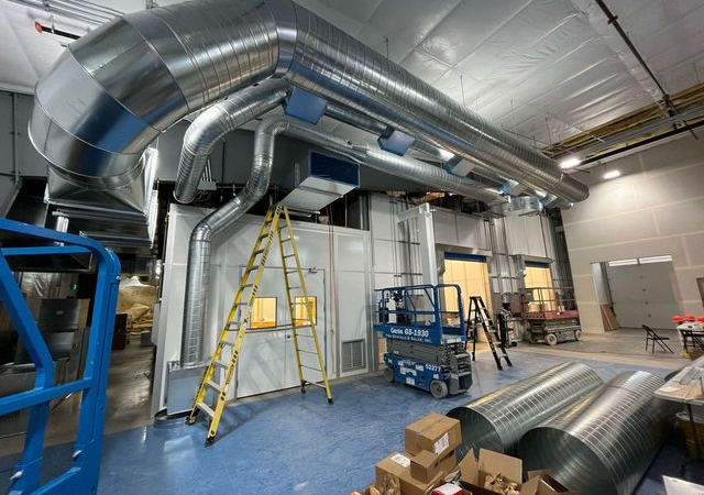 Assembling part of a cleanroom HVAC system.