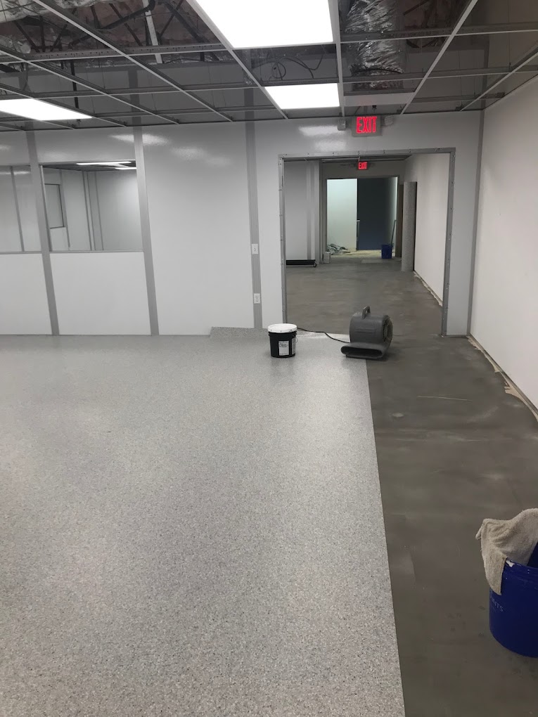 An ISO 4 cleanroom under construction, showcasing smooth, non-porous surfaces and modular wall systems for optimal contamination control.