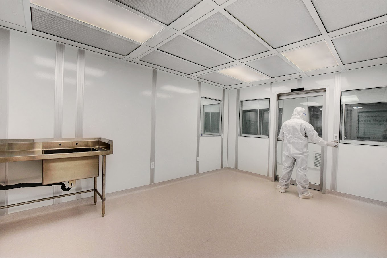 A man in gowning works in an ISO 4 cleanroom.