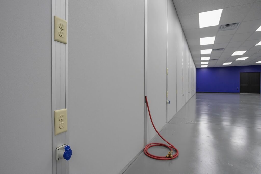 A cleanroom wall with smooth, non-porous surfaces designed to prevent particle accumulation.