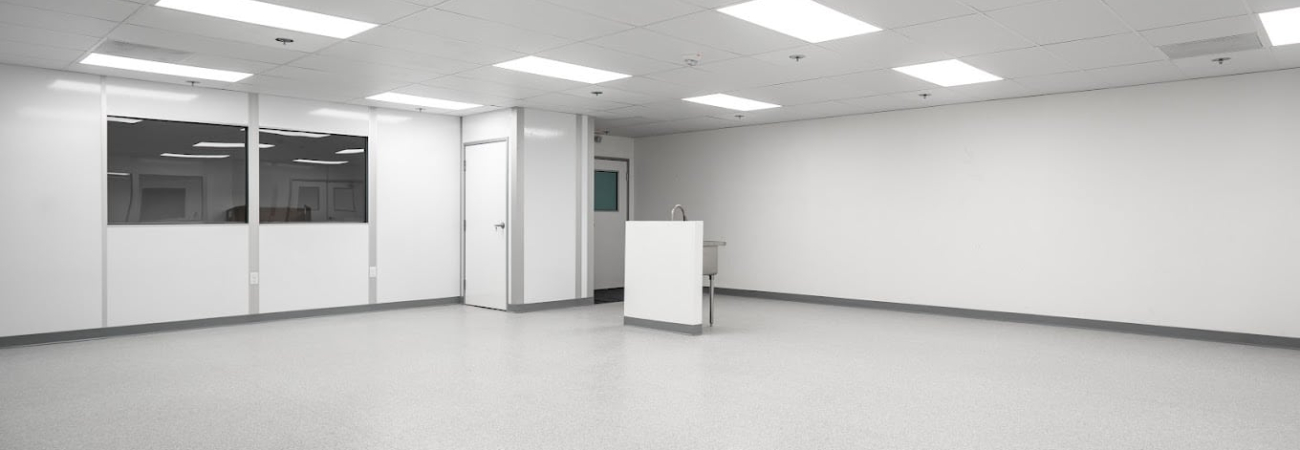 A clean, empty climate-controlled room with bright overhead lighting and smooth, sterile flooring.