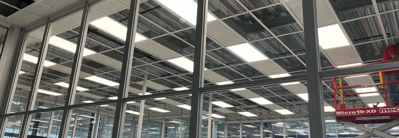Cleanroom ceiling installation by Allied Cleanrooms with full glass wall panels