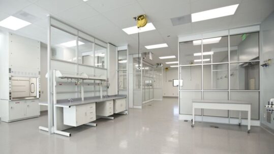 Modern pharmaceutical cleanroom featuring sterile workstations, overhead service carriers, and controlled environment modules for contaminant-free operations.