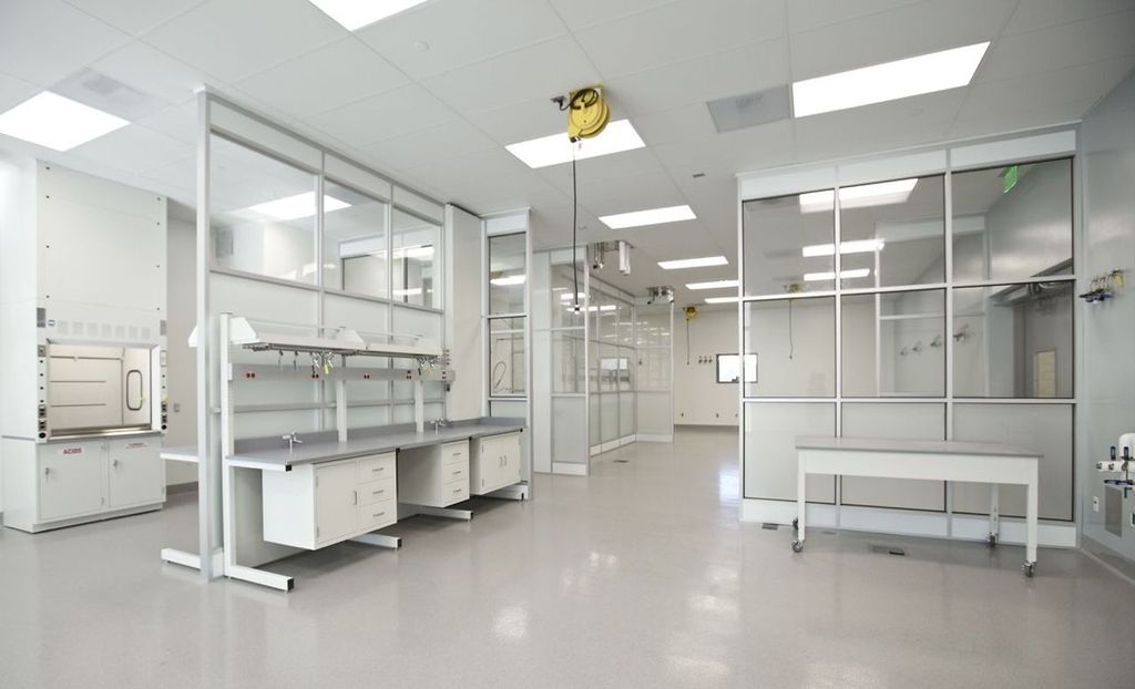 Modern pharmaceutical cleanroom featuring sterile workstations, overhead service carriers, and controlled environment modules for contaminant-free operations.