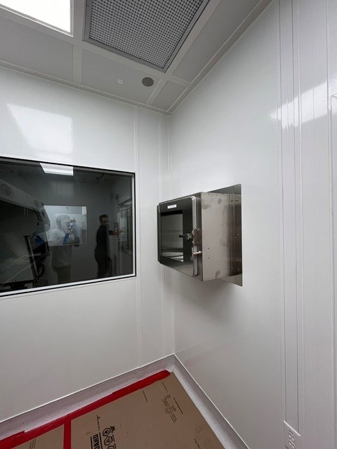 A stainless steel pass-through chamber installed in a cleanroom wall.