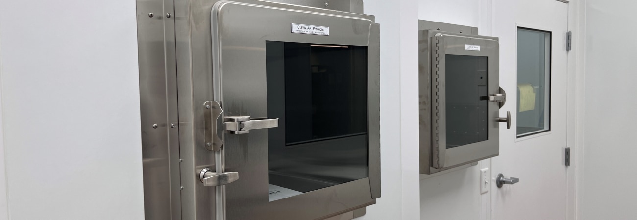 Stainless steel pass-through chamber in a GMP-compliant cleanroom built by Allied Cleanrooms.