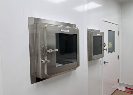 Stainless steel pass-through chamber in a GMP-compliant cleanroom built by Allied Cleanrooms.