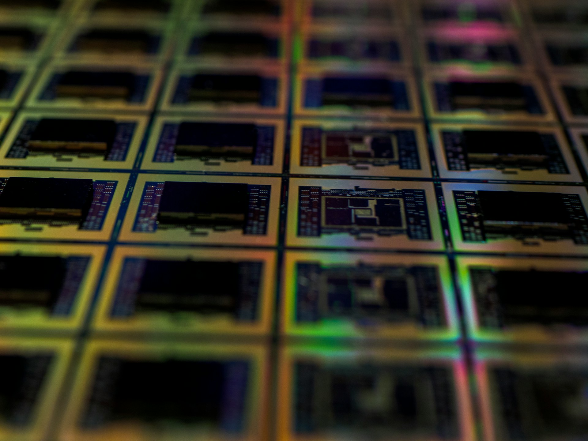Close-up image of semiconductor wafers with intricate circuitry patterns.