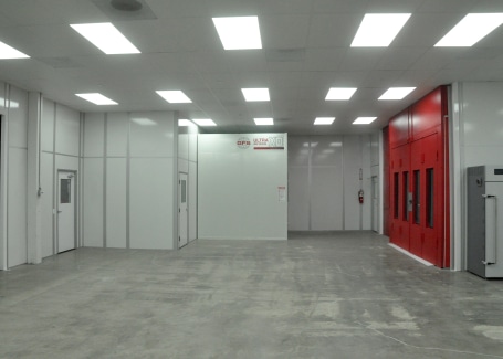 Automotive paint cleanroom by Allied Cleanrooms with modular walls and integrated lighting, designed for controlled painting or coating applications.