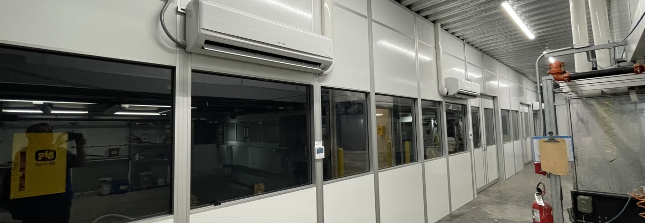 Modular hardwall cleanroom with windows and mounted HVAC units, built by Allied Cleanrooms.