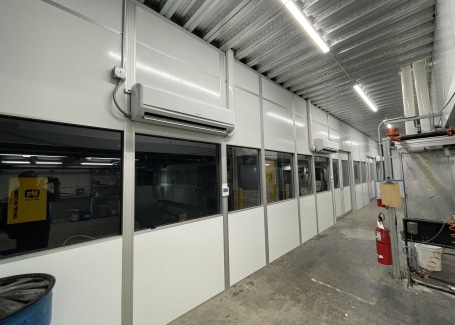 Modular hardwall cleanroom with windows and mounted HVAC units, built by Allied Cleanrooms.