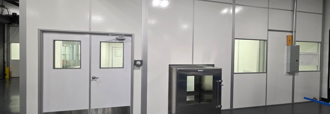 Anteroom with cleanroom entry doors and pass-through chamber by Allied Cleanrooms.