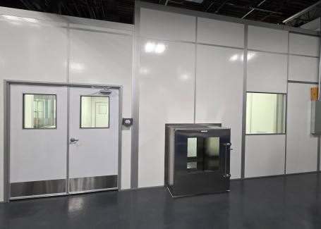 Anteroom with cleanroom entry doors and pass-through chamber by Allied Cleanrooms.