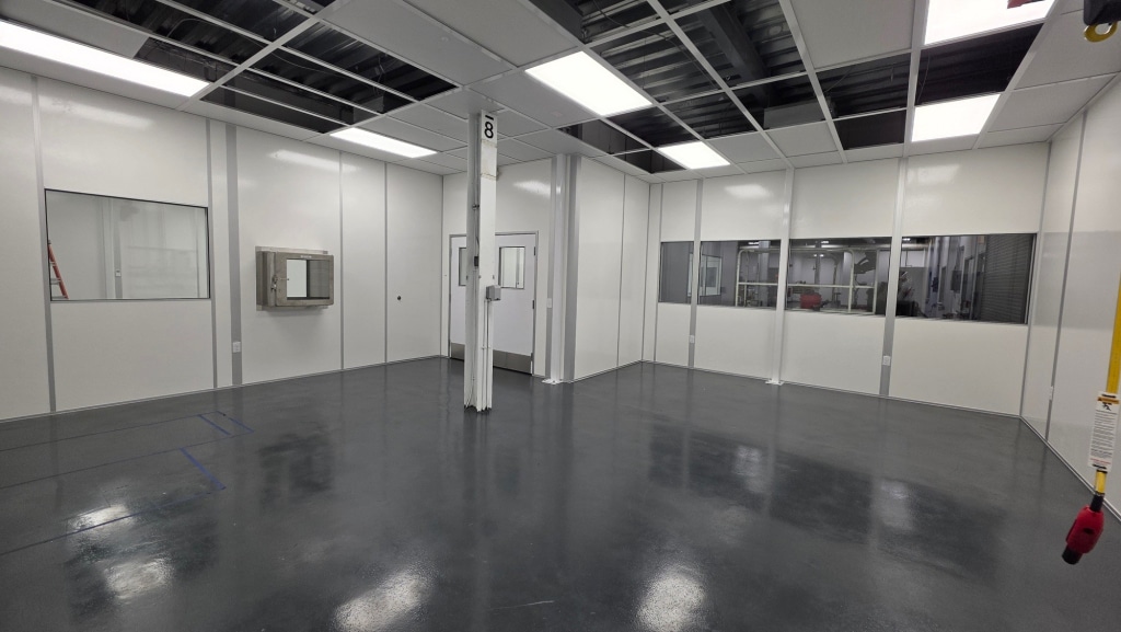 Modular cleanroom interior by Allied Cleanrooms with pass-through chamber and wall windows.