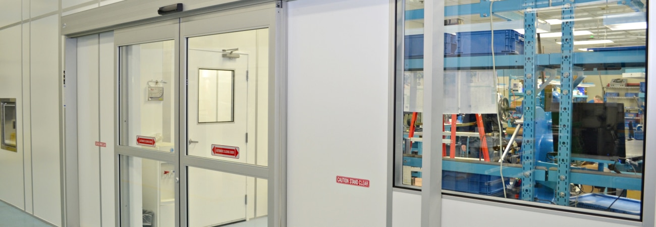 Modular nanotechnology cleanrooms built by Allied Cleanrooms, featuring an automatic sliding door and interior viewing window.