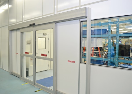 Modular nanotechnology cleanrooms built by Allied Cleanrooms, featuring an automatic sliding door and interior viewing window.