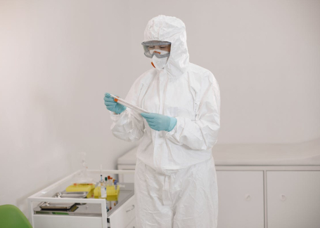 Technician in full protective suit performing cleanroom testing at an Allied Cleanrooms facility.