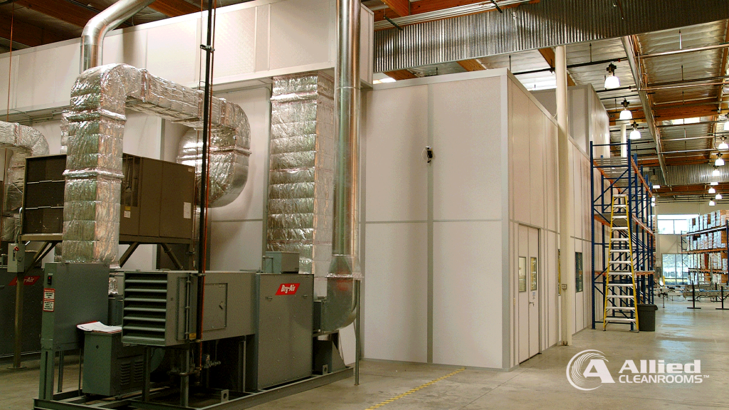 Allied Cleanrooms modular cleanroom exterior with connected air handling equipment and insulated ductwork inside a warehouse facility