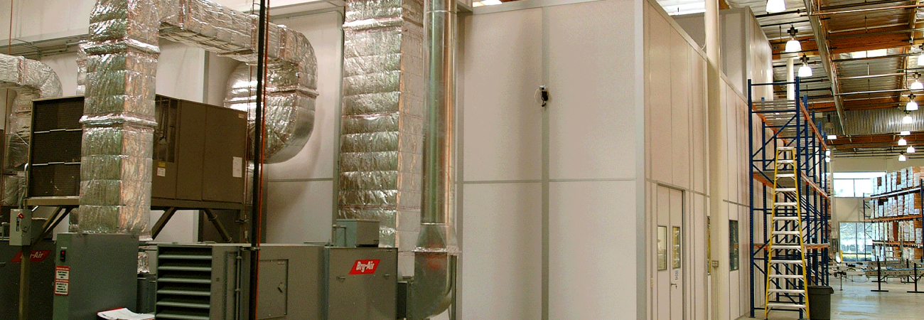 Allied Cleanrooms modular cleanroom exterior with connected air handling equipment and insulated ductwork inside a warehouse facility
