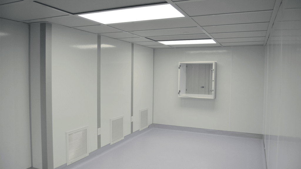 Interior of a 503B cGMP cleanroom built by Allied Cleanrooms, showing smooth wall panels, return air grilles, and a pass-through chamber.