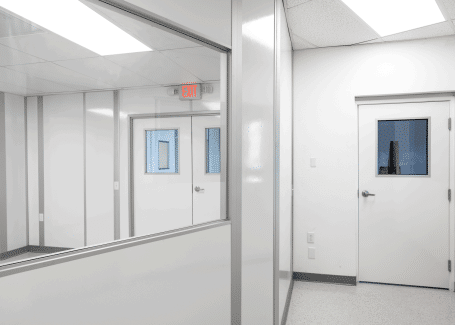Modular cleanroom corridor with interior windows and sealed doors, built by Allied Cleanrooms for optimized post-build cleanroom planning.