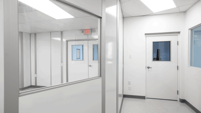 Modular cleanroom corridor with interior windows and sealed doors, built by Allied Cleanrooms for optimized post-build cleanroom planning.