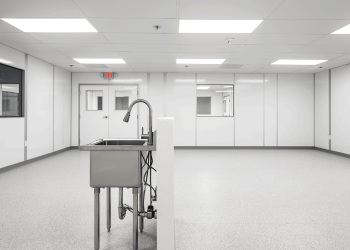 Interior of an Allied Cleanrooms cleanroom with sealed wall panels, double doors, and windows into adjacent rooms for cleanroom pressure cascade airflow control